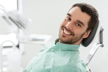 A smiling man in the dentist's chair