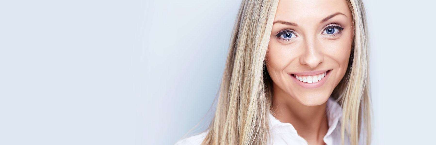 smiling woman after cosmetic dentistry in St. Augustine, FL