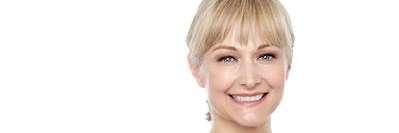 A smiling woman in a white room