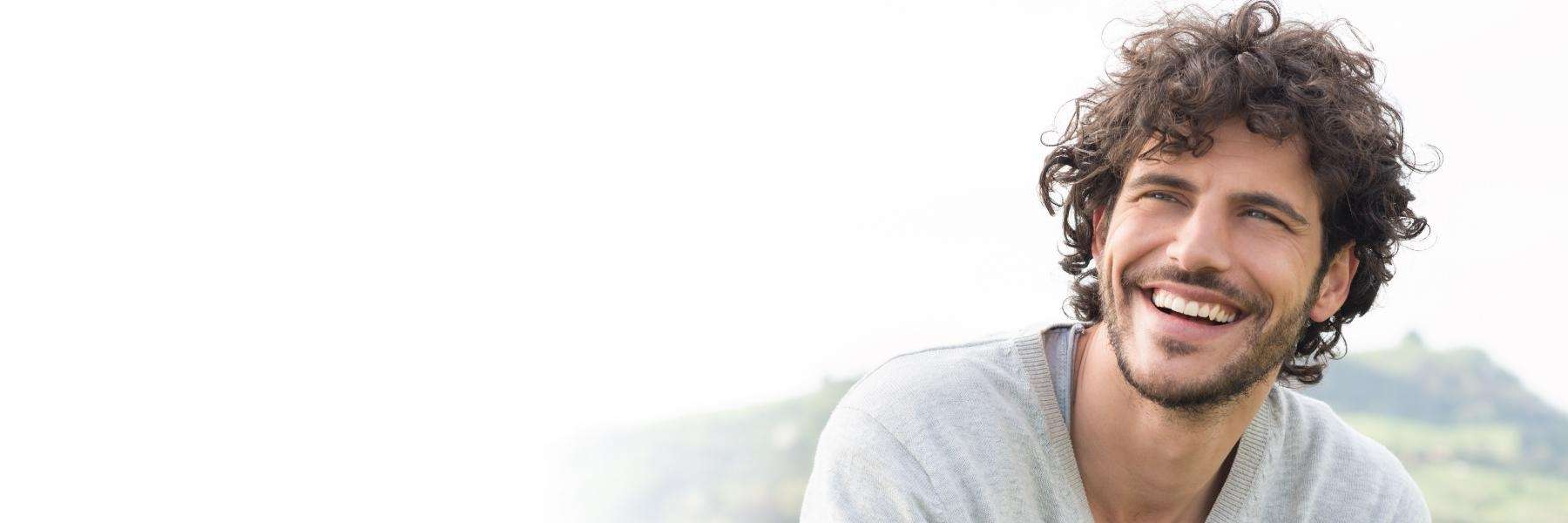 A man smiling outdoors | dentist florida