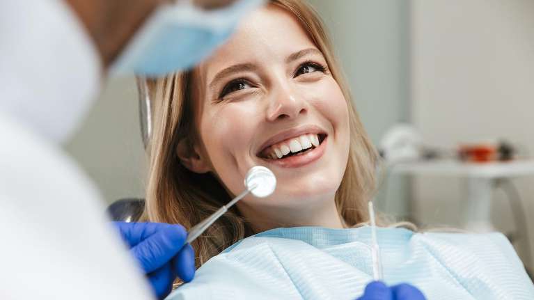 A woman getting a dental exam | St Augustine Dentist