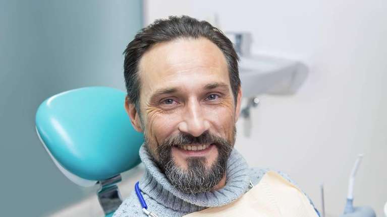 A smiling man in the dentist's chair | dentist in st augustine