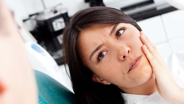 A woman with jaw pain | dentist st augustine