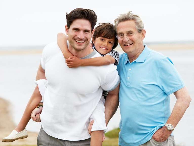 A smiling family posing by the lake | dentist st augustine fl