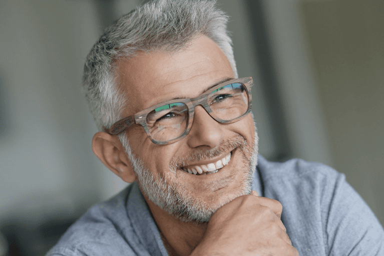 A smiling man with glasses | st augustine dentist