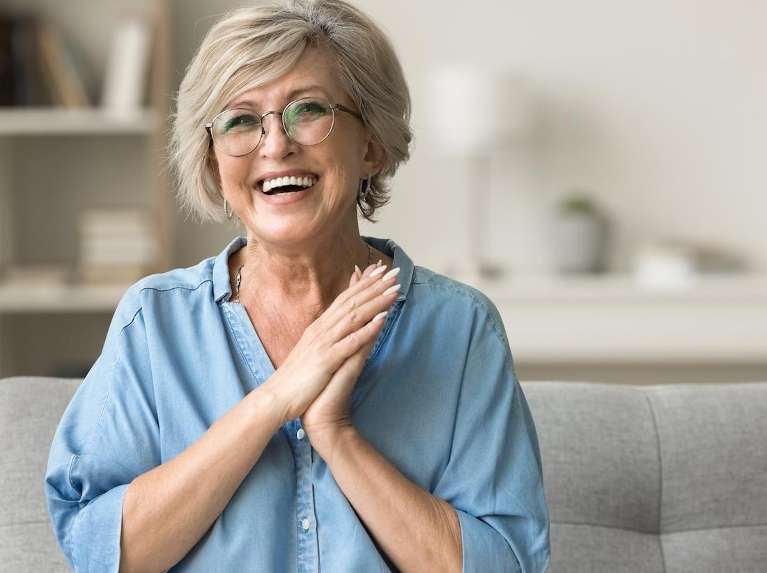 An elderly lady after a visit to a trusted dentist in St. Augustine, FL