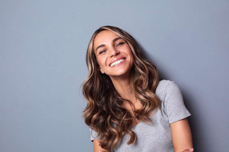 A woman smiling after getting Porcelain Veneers in St. Augustine