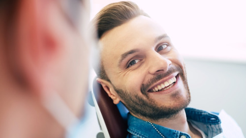 Smiling man relaxing in a dental chair during a check up visit in St. Augustine, FL