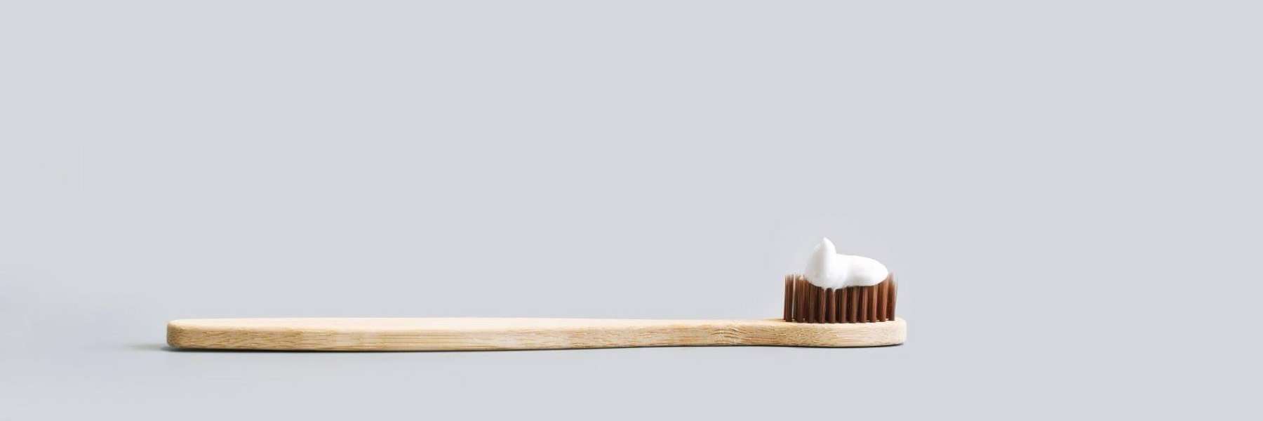 A wooden toothbrush with toothpaste on it, st augustine fl