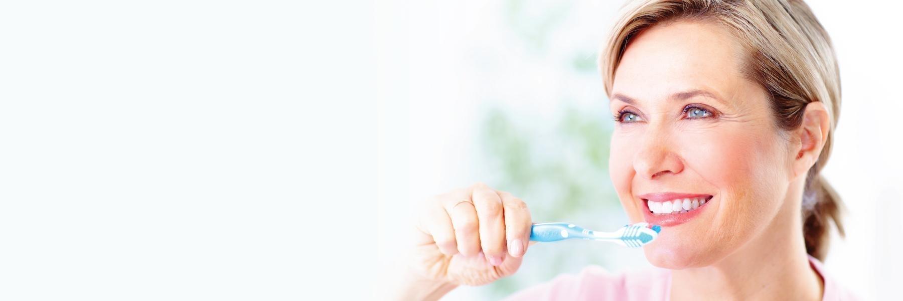 close up of woman brushing teeth