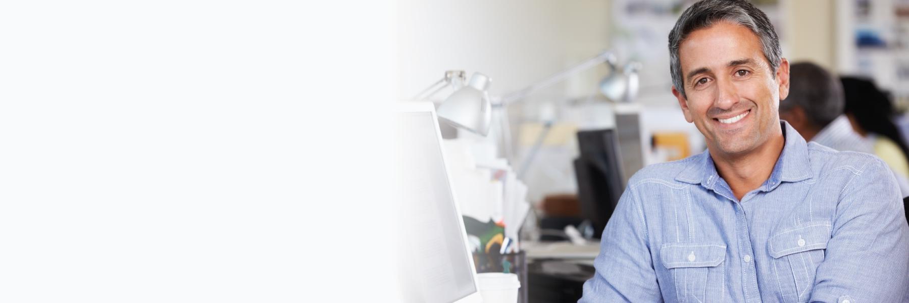 Man smiling while sitting at desk